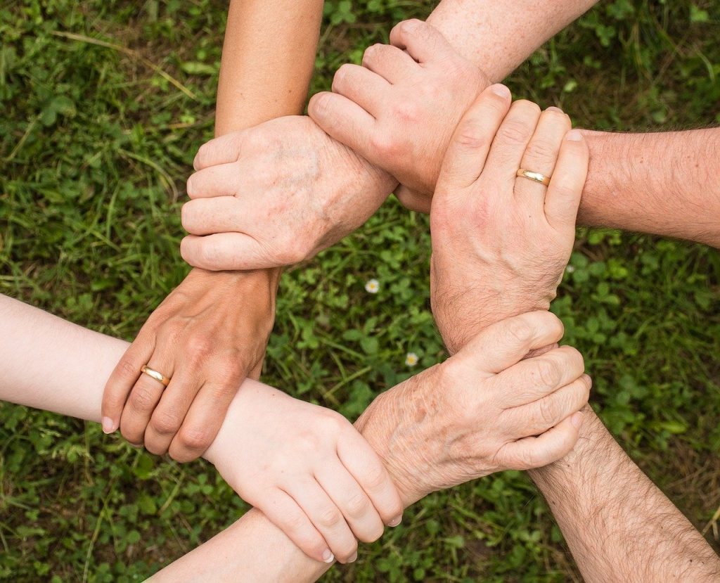 People linking hands.
