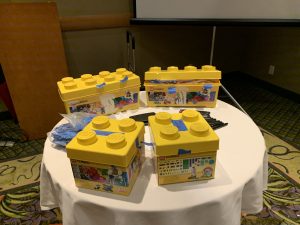 Yellow lego building boxes on the table.