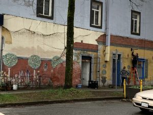 The side of a house that is painted with graffiti.